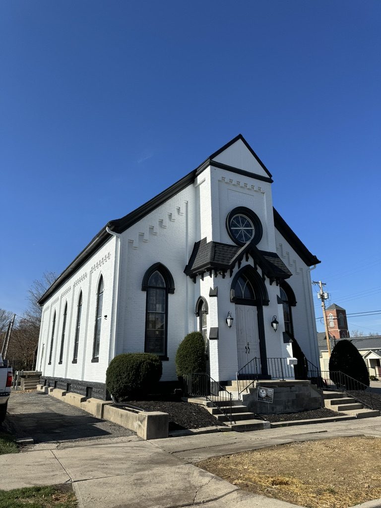 Historic brick church painted white with black trim by Turner Painting