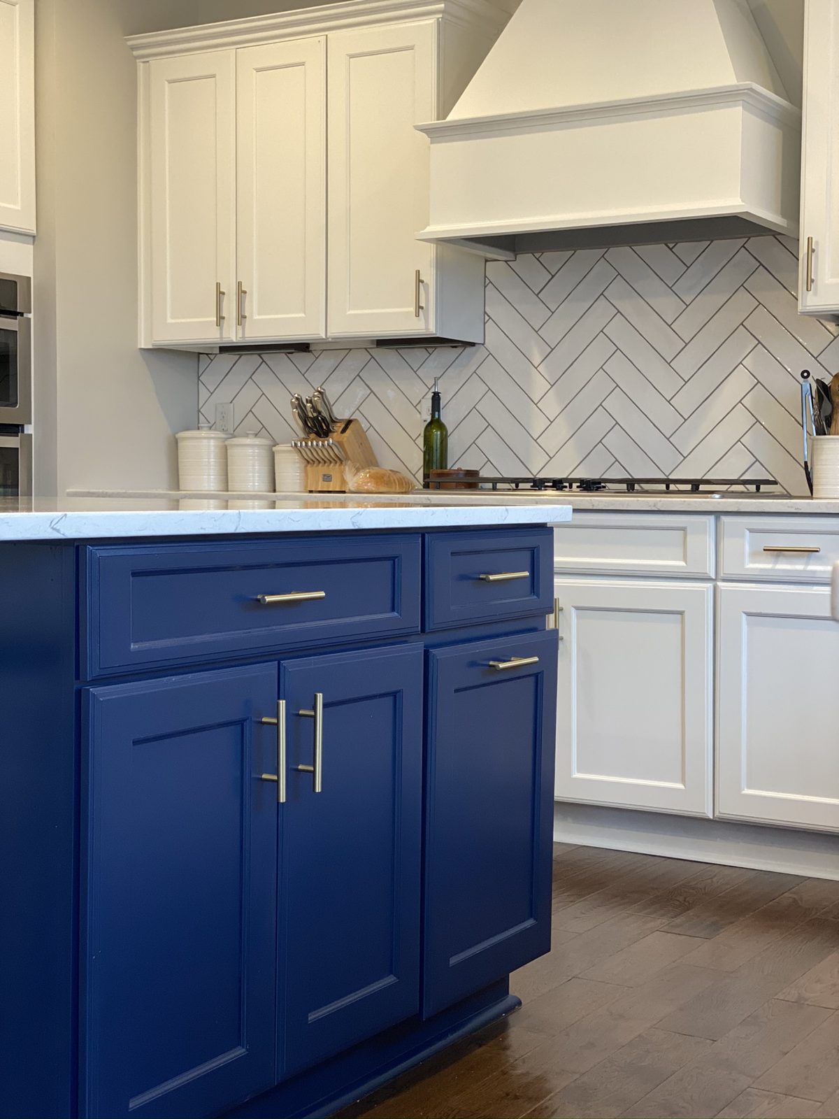 Navy blue painted kitchen island with white cabinets in Liberty Township, OH