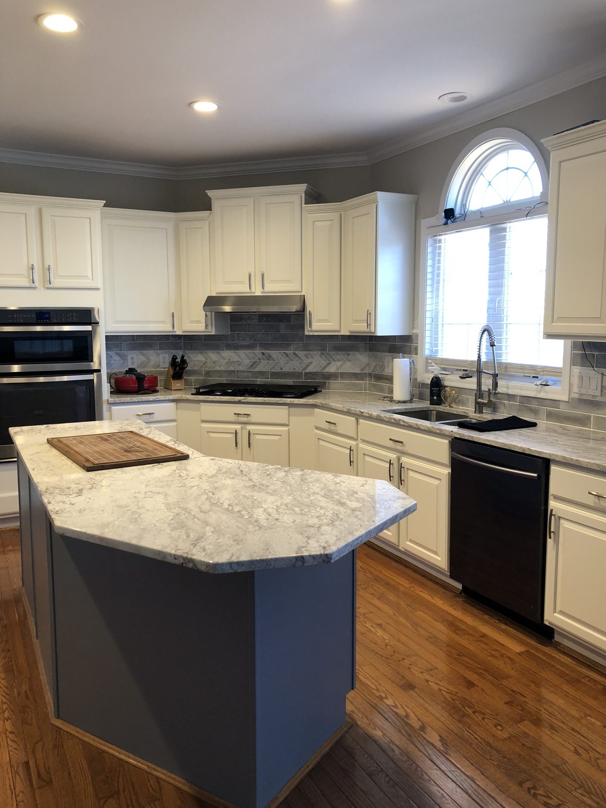 White painted kitchen cabinets with slate blue island in Monroe, OH